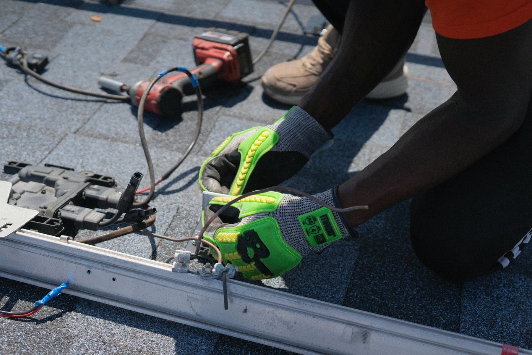 Solar technician working on rooftop solar equipment
